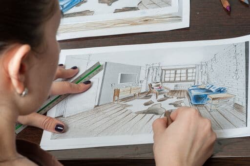 personne dessinant un plan design